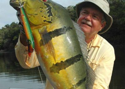 Angler with his peacock bass catch